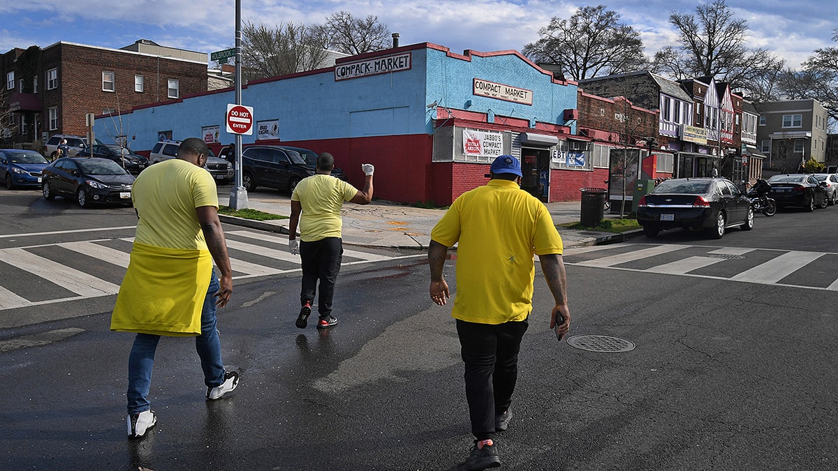 Members of the "Cure the Streets" squad head to a local market to interact with local youths in N.E. Washington, D.C. on March 20, 2020. (Photo by Michael S. Williamson/The Washington Post via Getty Images)