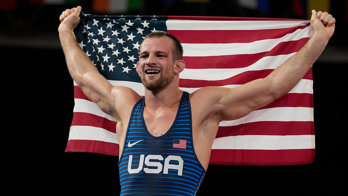 United States' David Morris Taylor III celebrates holding the US flag after winning the gold medal in the men's 86kg Freestyle wrestling event at the 2020 Summer Olympics,
