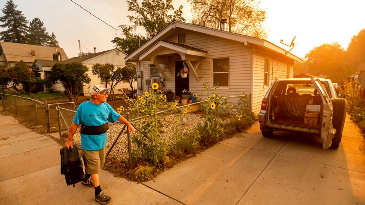 As the Dixie Fire burns towards Susanville, Calif., Gary Mooney prepares to evacuate from his home on Monday, Aug. 16, 2021.