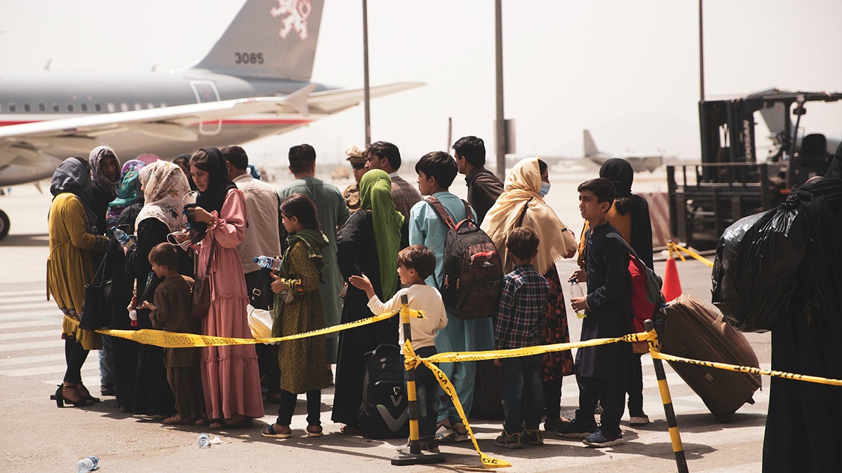 Afghans board military plane