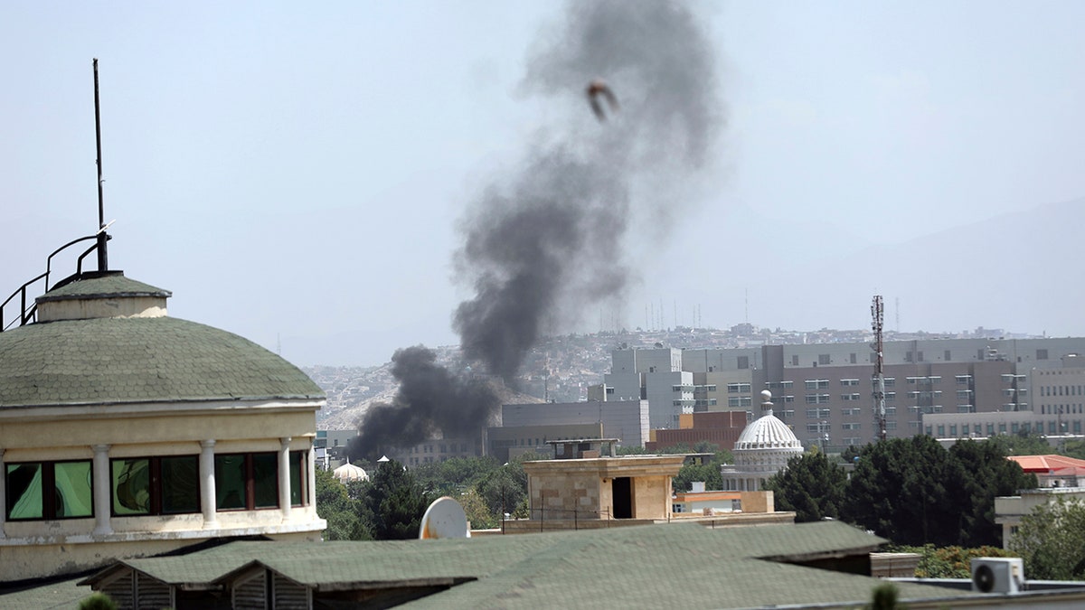 Smoke rises next to the U.S. Embassy in Kabul, Afghanistan, Sunday, Aug. 15, 2021.