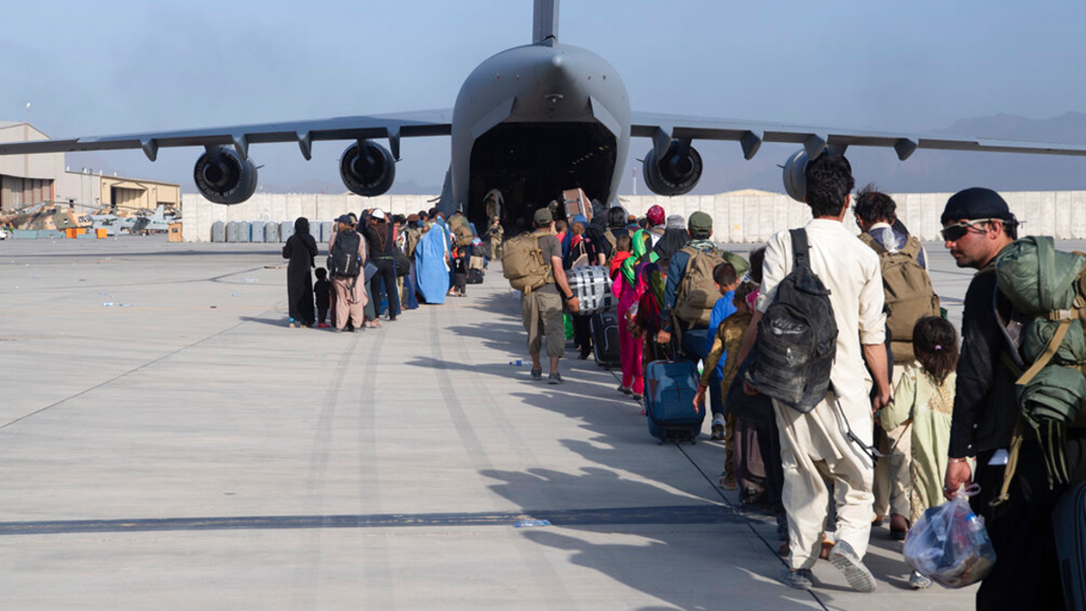 U.S. Air Force loadmasters and pilots assigned to the 816th Expeditionary Airlift Squadron, load people being evacuated from Afghanistan onto a U.S. Air Force C-17 Globemaster III at Hamid Karzai International Airport in Kabul, Afghanistan, Tuesday, Aug. 24, 2021. 