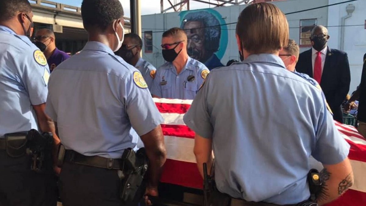 New Orleans police officers hold a casket with Det. Everett Briscoe's body. Briscoe was killed this past weekend while visiting Houston with members of the Zulu Social Aid and Pleasure Club.