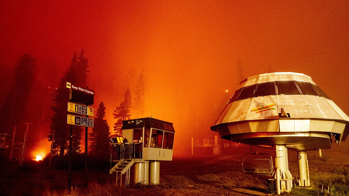Flames surround a chair lift at Sierra-at-Tahoe Resort, a skiing area, during the Caldor fire in Twin Bridges, California on August 30, 2021. (Photo by JOSH EDELSON / AFP) (Photo by JOSH EDELSON/AFP via Getty Images)
