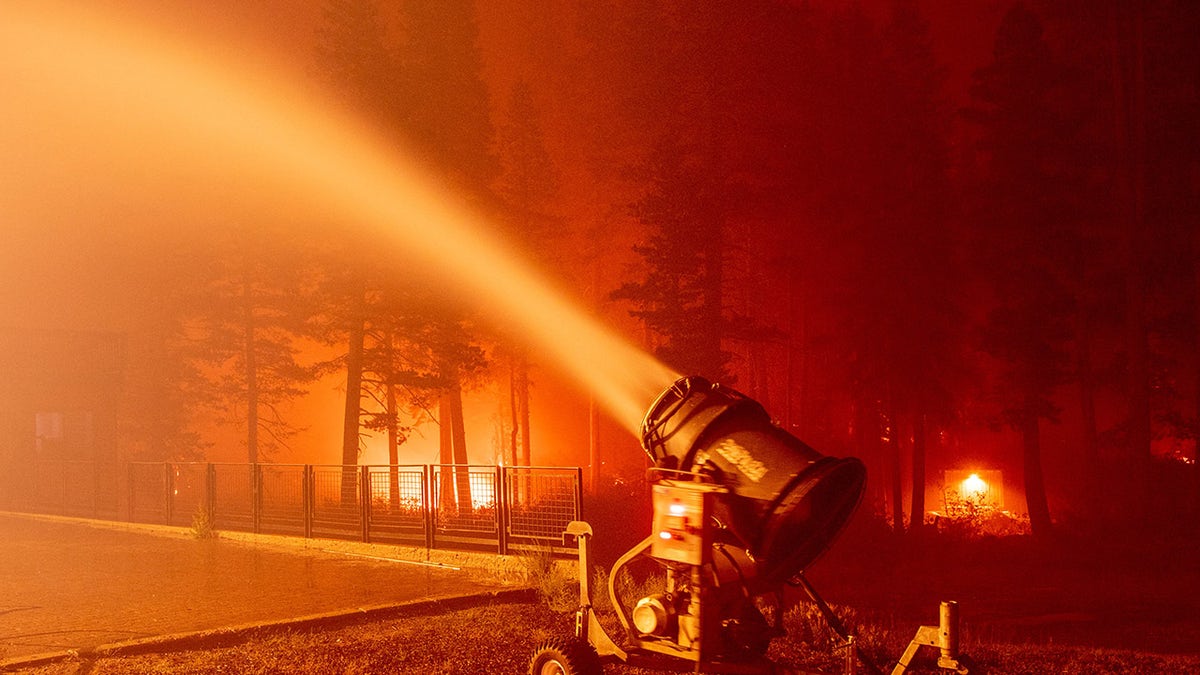 A snow gun sprays water at the Sierra-at-Tahoe Resort during the Caldor fire in Twin Bridges, California on August 30, 2021.