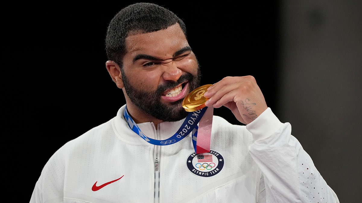 United State's Gable Dan Steveson celebrates with his gold medal during the victory ceremony for men's freestyle 125kg wrestling at the 2020 Summer Olympics