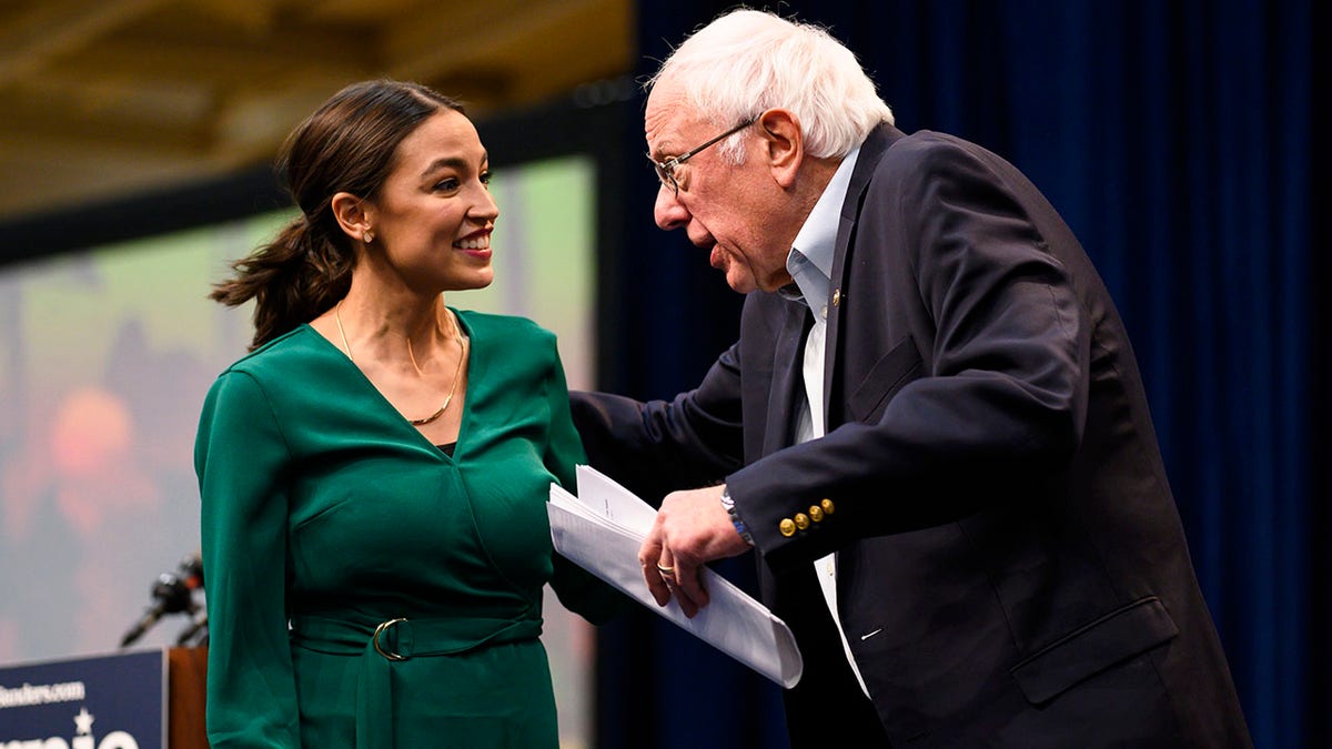Bernie Sanders and Alexandria Ocasio-Cortez during climate summit at Drake University