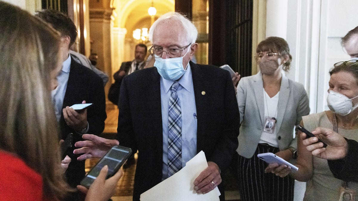 Sen. Bernie Sanders, I-Vt., wears a protective mask while exiting the U.S. Capitol in Washington, D.C., on Monday, Aug. 9, 2021. The Senate moved closer to passing a $550 billion infrastructure package after a drawn-out debate pushed action into this week and left the status of several proposed changes unsettled. Photographer: Ting Shen/Bloomberg via Getty Images
