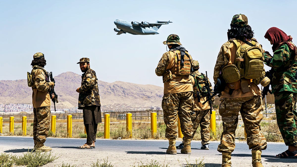 A C-17 Globemaster takes off as Taliban fighters secure the outer perimeter, alongside the American controlled side of the Hamid Karzai International Airport in Kabul, Afghanistan, Sunday, Aug. 29, 2021. (MARCUS YAM / LOS ANGELES TIMES)