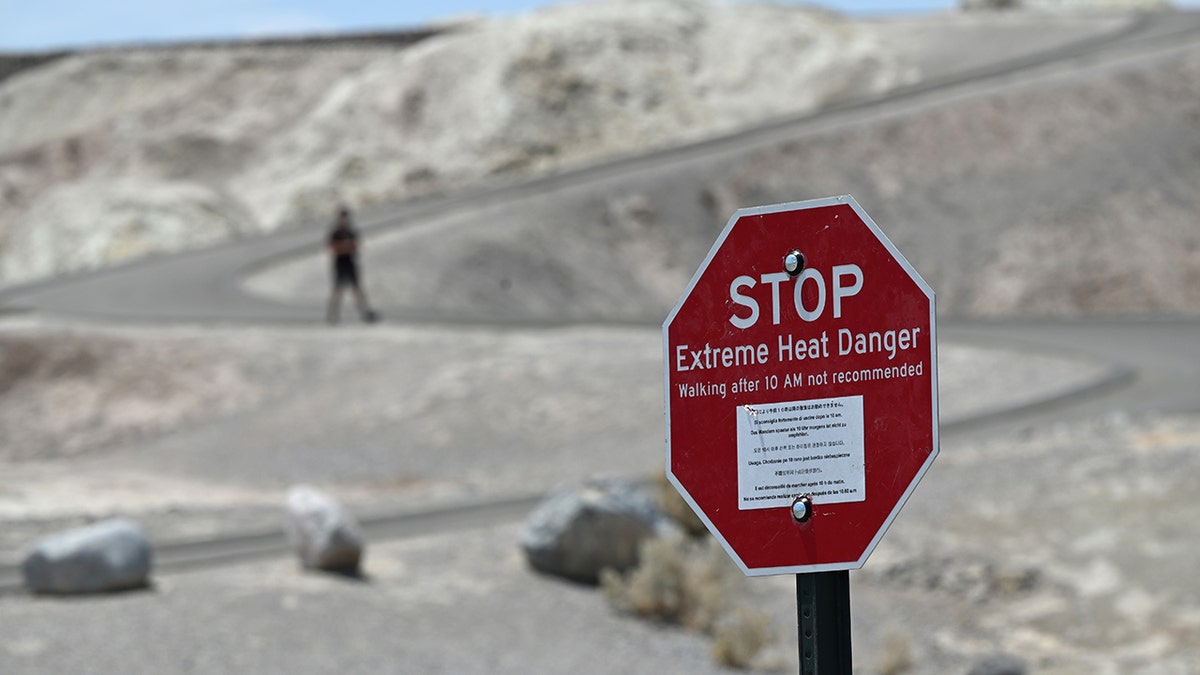 A warning sign alerts visitors of heat dangers at Zabriskie Point on July 11, 2021 in Death Valley National Park, California. (Getty Images)