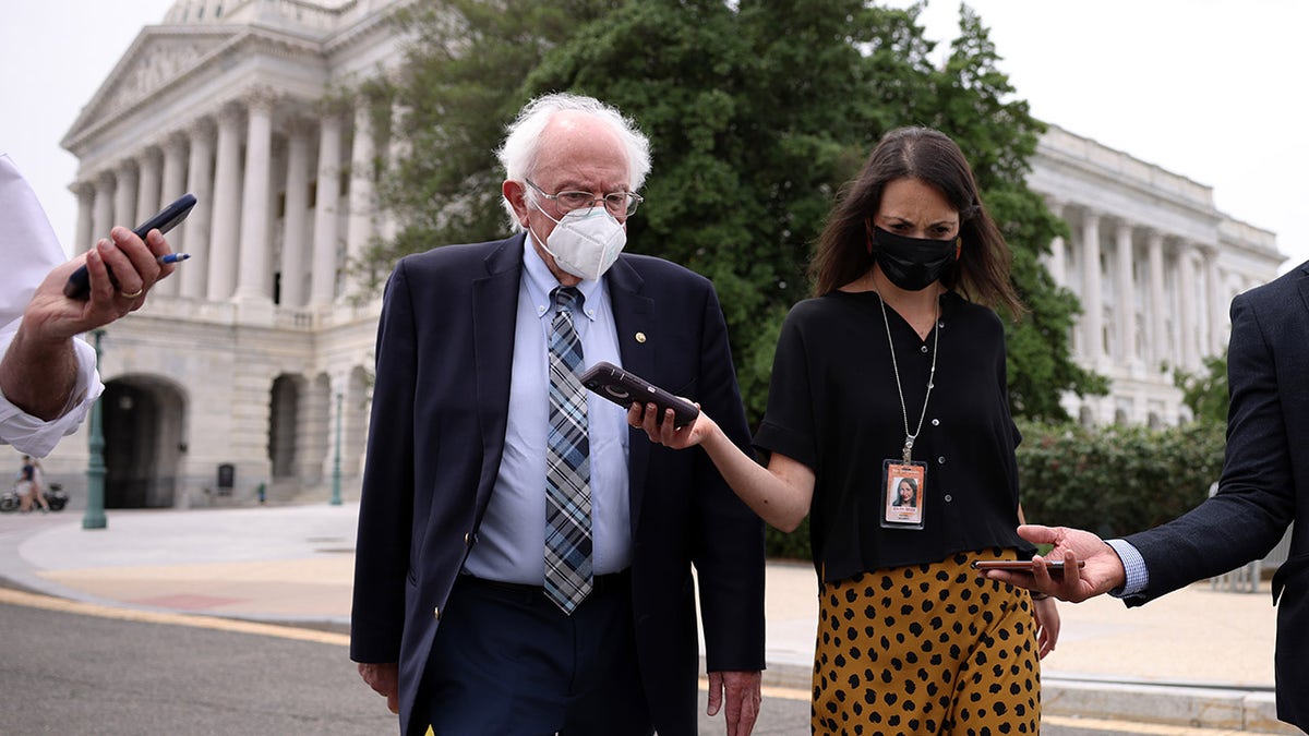Bernie Sanders speaks to a reporter
