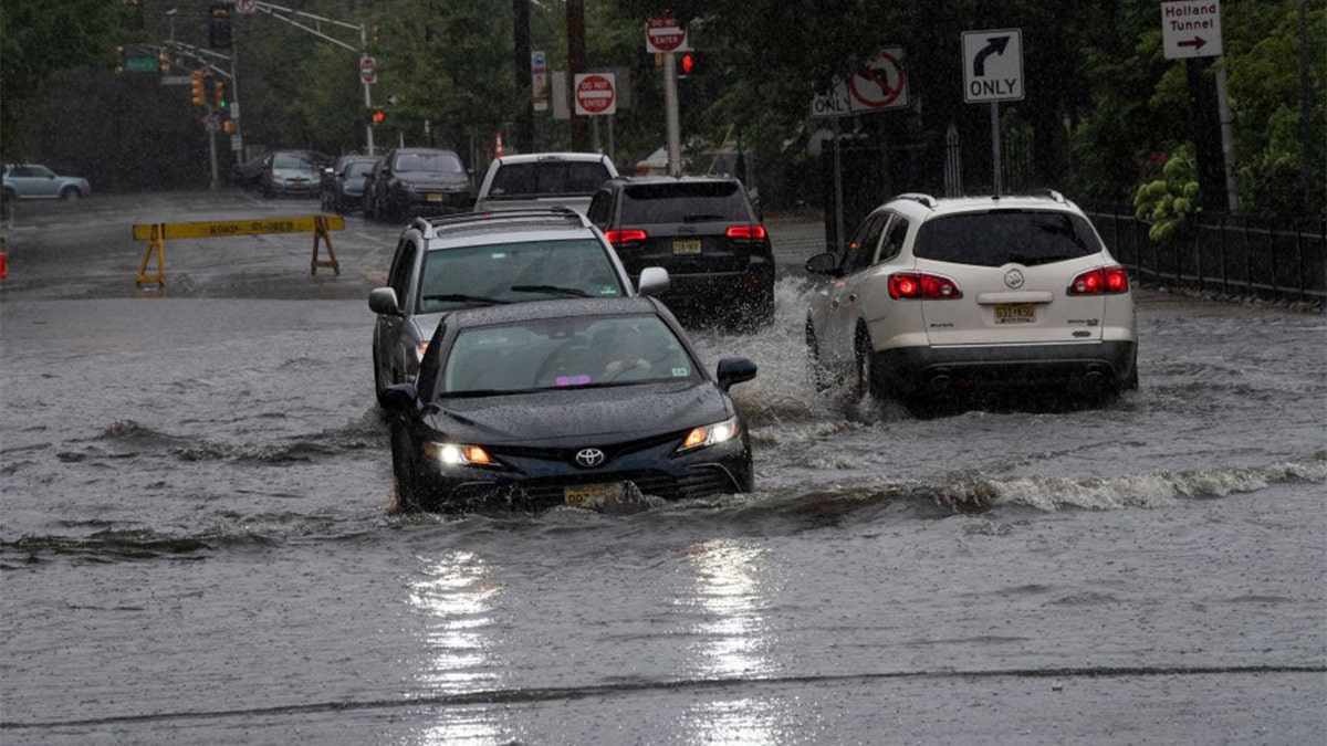 Cars drive through high water