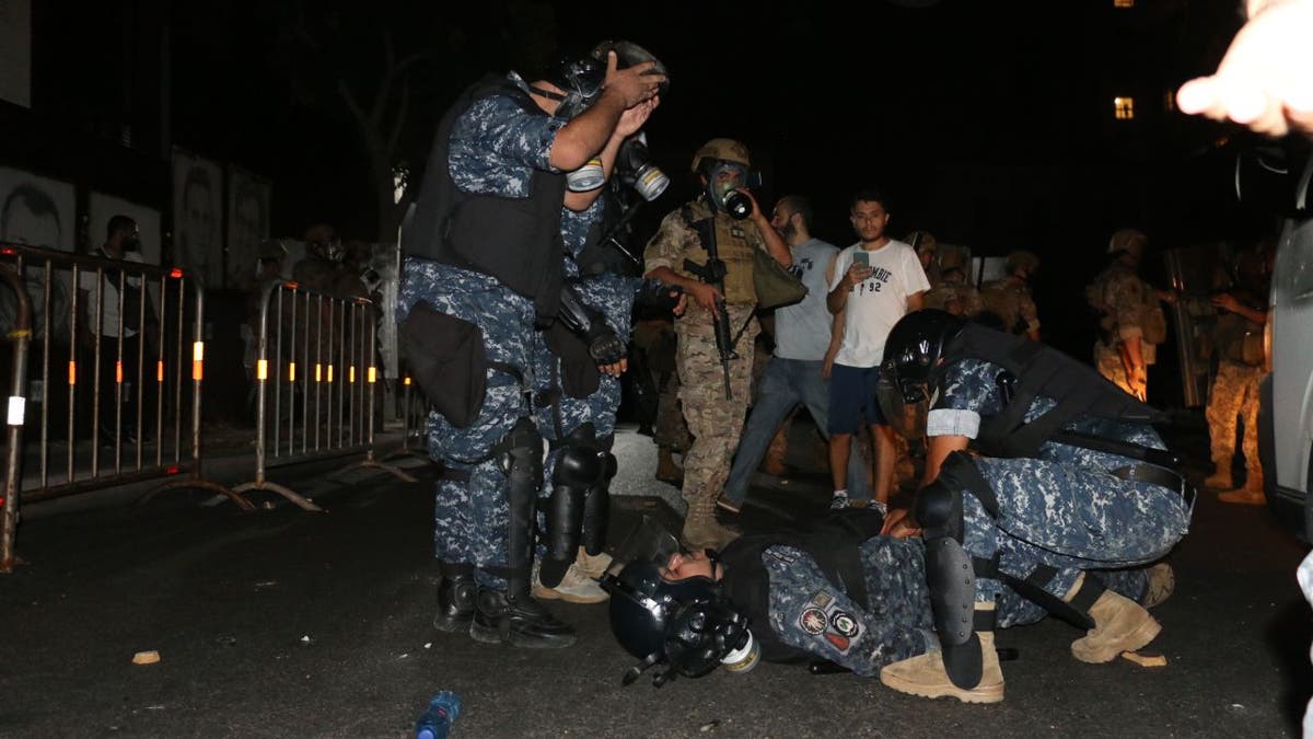 An injured security officer during demonstrations on the anniversary of a massive explosion in Beirut.