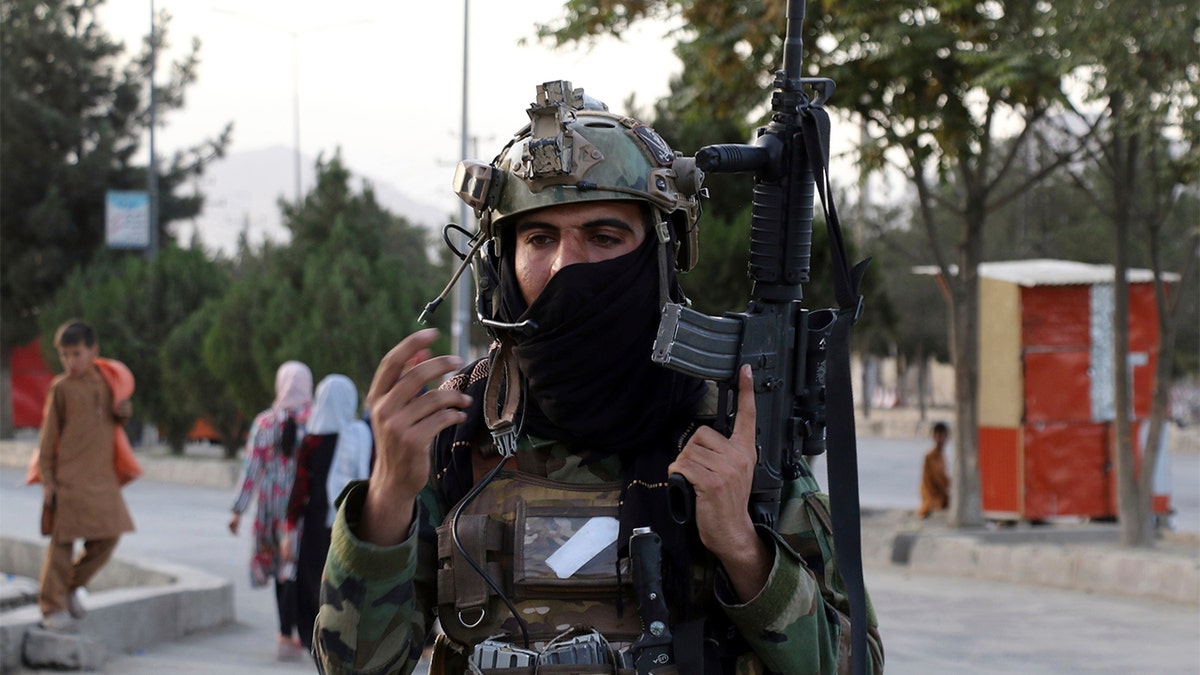 Taliban fighter stand guard at a checkpoint near the gate of Hamid Karzai international Airport in Kabul, Afghanistan, Saturday, Aug. 28, 2021