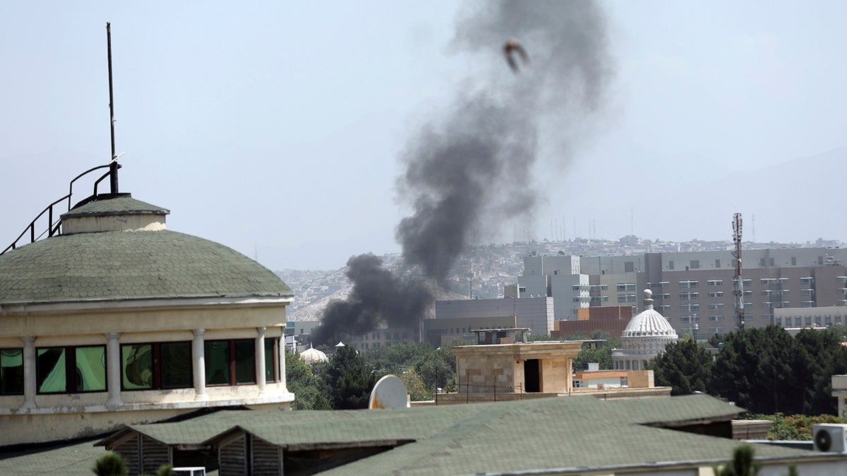 Smoke rises next to the U.S. Embassy in Kabul, Afghanistan, Sunday, Aug. 15, 2021. Taliban fighters entered the outskirts of the Afghan capital on Sunday, further tightening their grip on the country as panicked workers fled government offices and helicopters landed at the embassy. Wisps of smoke could be seen near the embassy's roof as diplomats urgently destroyed sensitive documents, according to two American military officials. 
