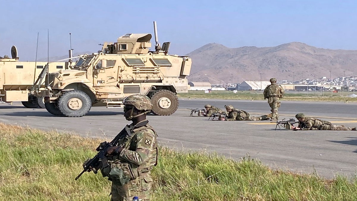 U.S soldiers stand guard along a perimeter at the international airport in Kabul on Monday.