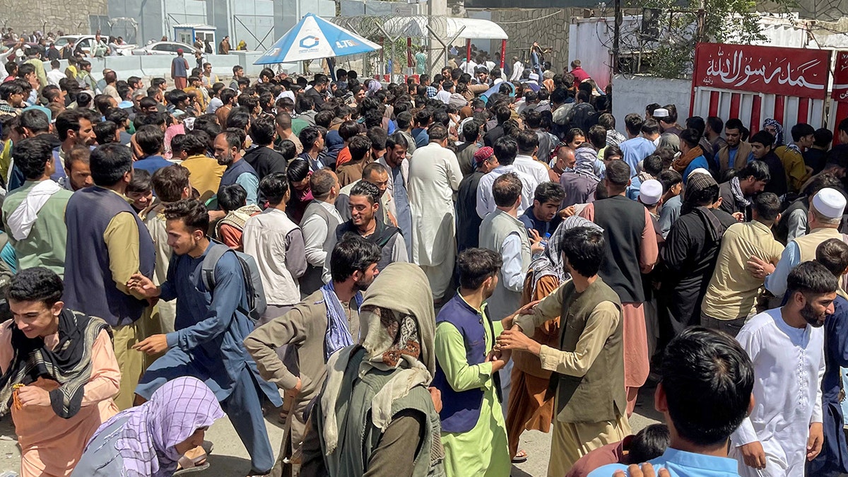 People try to get into Hamid Karzai International Airport in Kabul, Afghanistan August 16, 2021. (REUTERS/Stringer)