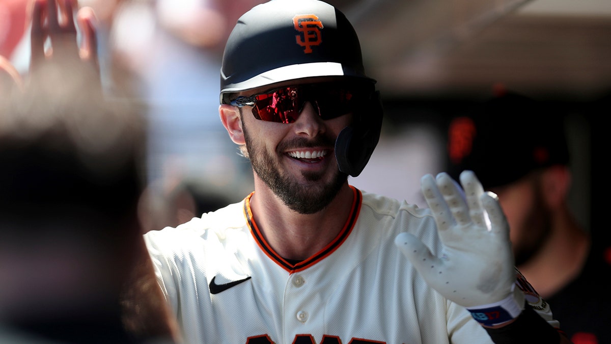 San Francisco Giants' Kris Bryant is congratulated by teammates after hitting a home run against the Houston Astros during the third inning of a baseball game in San Francisco, Sunday, Aug. 1, 2021. (AP Photo/Jed Jacobsohn)