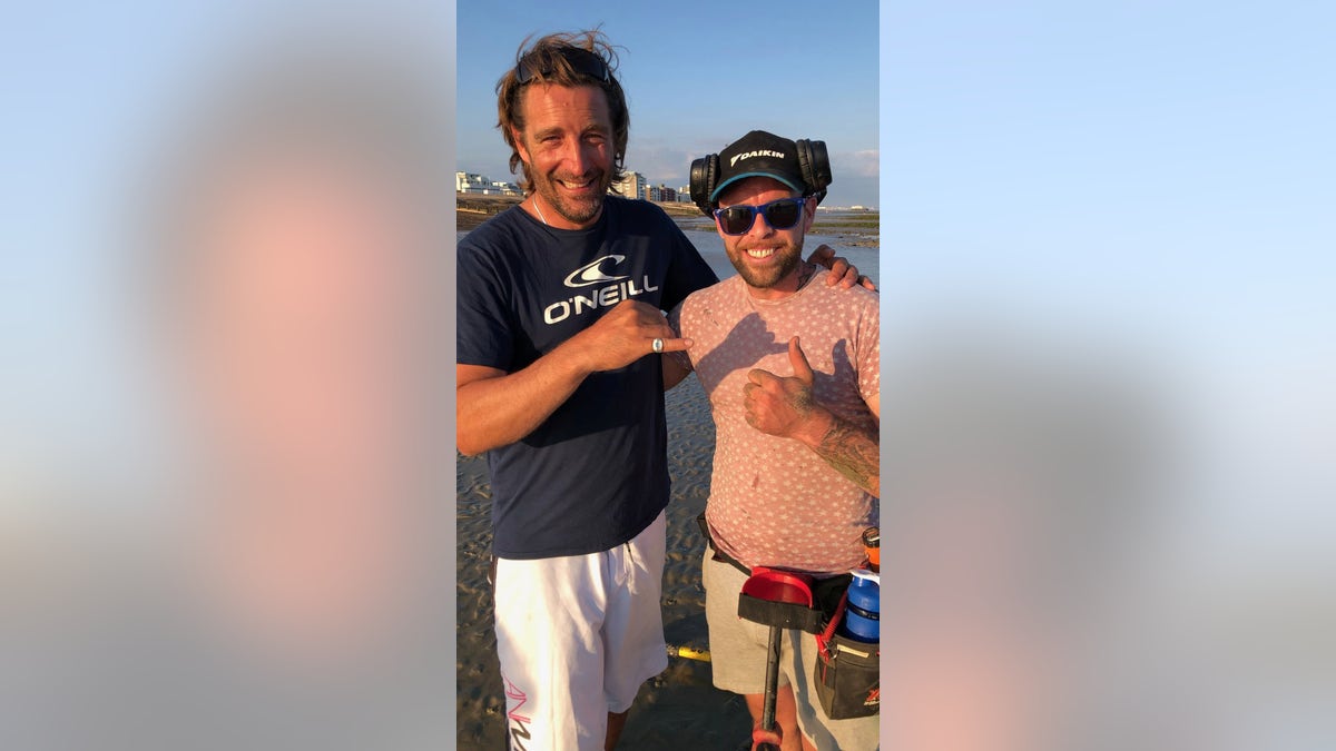 Robin Hallett (left) is pictured with Goldsmith (right) after Goldsmith found Hallett's missing ring with his metal detector.