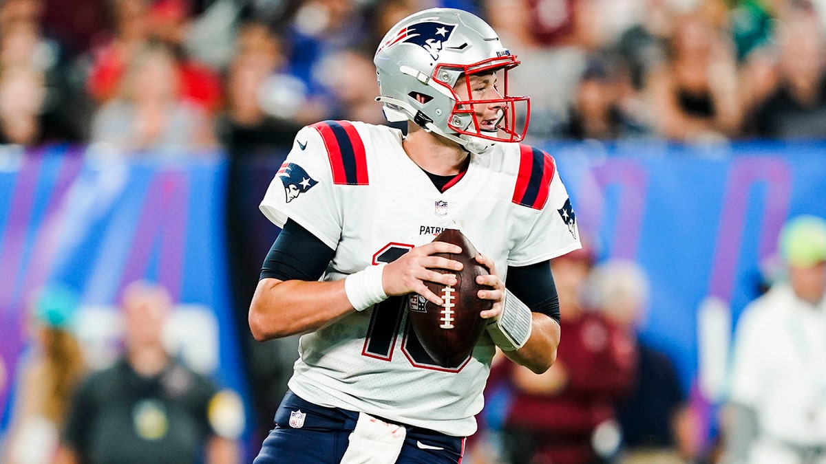 New England Patriots quarterback Mac Jones (10) drops back to pass during the second half of an NFL preseason football game against the New York Giants Sunday, Aug. 29, 2021, in East Rutherford, New Jersey. (AP Photo/John Minchillo)