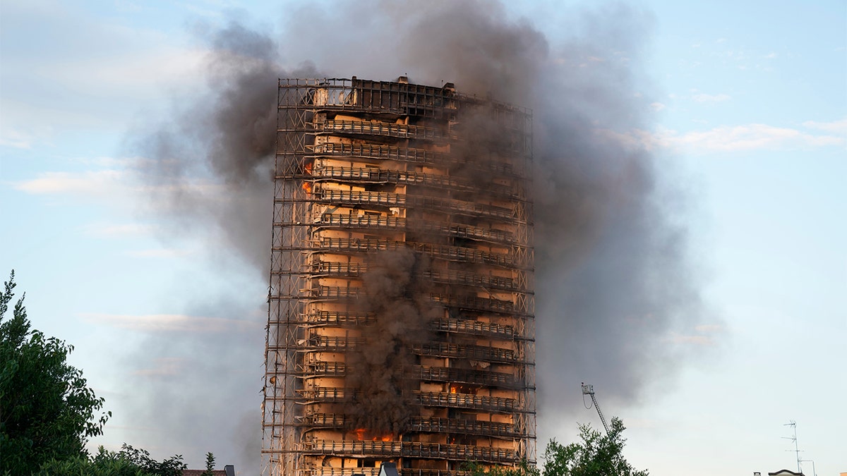 Smoke billows from a building in Milan, Italy, Sunday, Aug. 29, 2021.  (AP Photo/Luca Bruno)