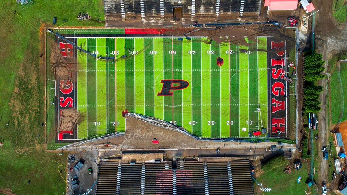 In this image taken with a drone, volunteers clear debris and try to salvage athletic equipment Thursday, Aug. 19, 2021 at Pisgah High School in Canton, N.C., after remnants from Tropical Storm Fred caused flooding in parts of Western North Carolina Tuesday.