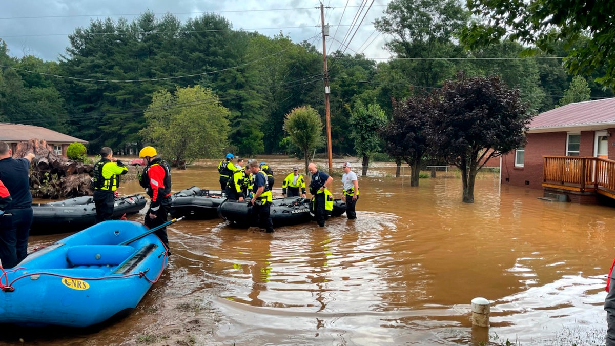 In this image provided by New Hanover County Fire Rescue, members of North Carolina’s Task Force 11, based in New Hanover County, are shown during rescue efforts in Canton, N.C, on Tuesday, Aug. 17, 2021. Authorities said that dozens of water rescues were performed after the remnants of Tropical Storm Fred dumped rain on the mountains of North Carolina. (New Hanover County Fire Rescue via AP)