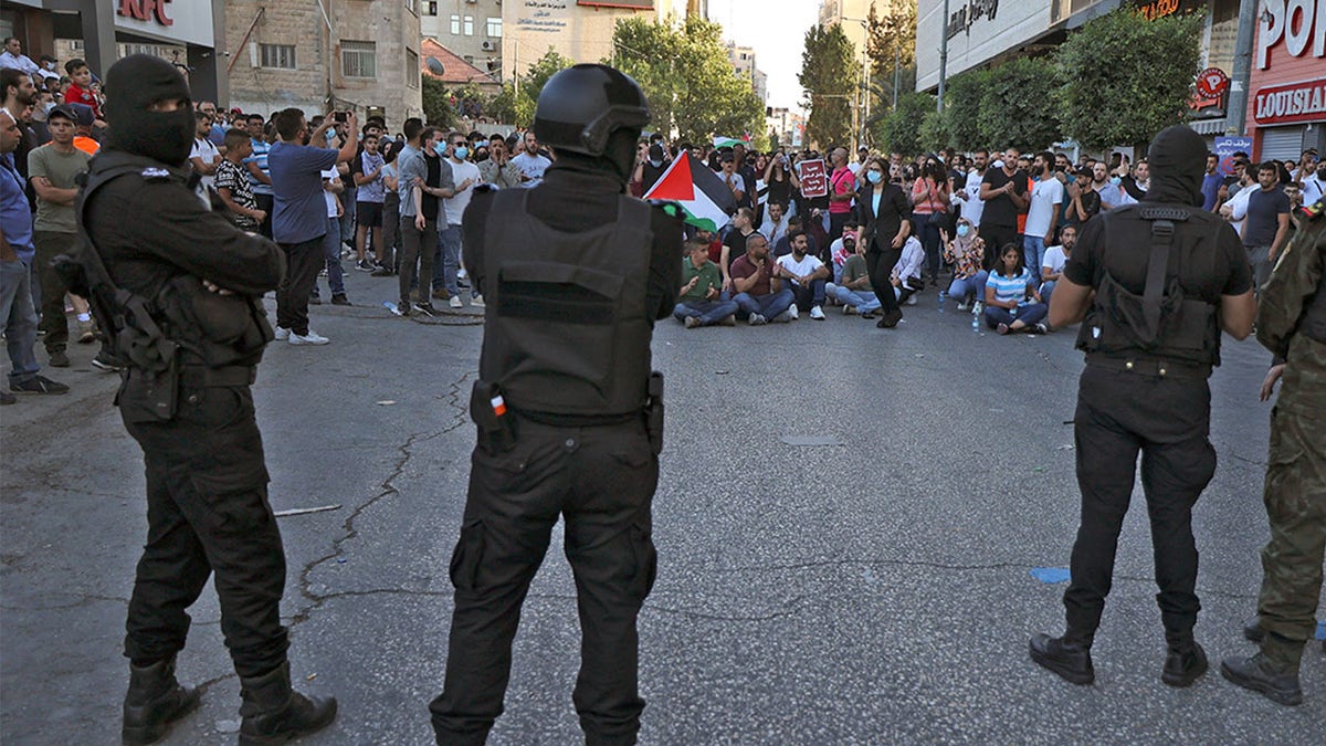 Palestinian security forces deploy as demonstrators rally in Ramallah city in the occupied West Bank on July 3, 2021. 