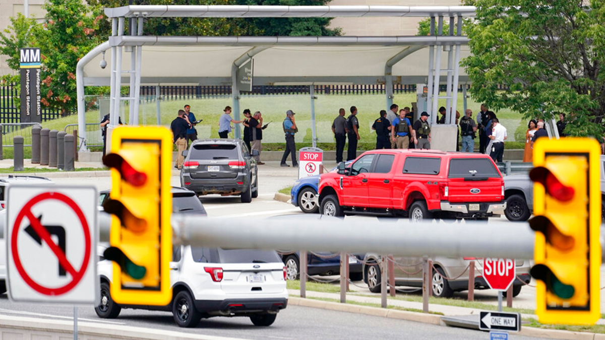 Police vehicles are seen outside the Pentagon Metro area Tuesday, Aug. 3, 2021, at the Pentagon in Washington. The Pentagon is on lockdown after multiple gunshots were fired near a platform by the facility's Metro station. 