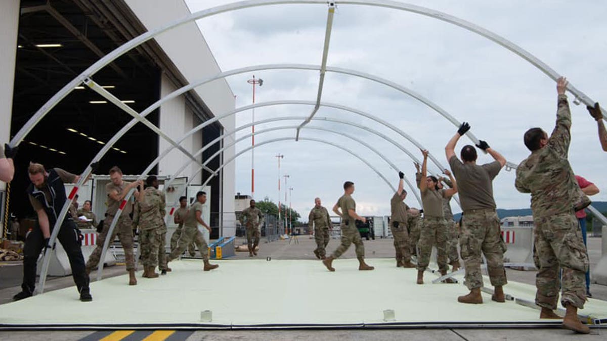 U.S. military personnel and volunteers make preparations for arriving evacuees at Ramstein Air Base in Germany. (Ramstein Air Base photo)