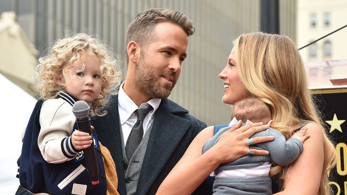 Ryan Reynolds and Blake Lively pose on the red carpet with their children in 2016.