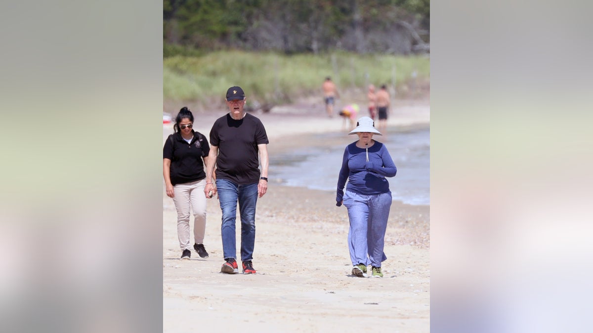 EXCLUSIVE: Bill Clinton and Hillary Clinton are spotted taking a walk along the beach near their home in The Hamptons, east of New York City. The couple just days ago celebrated Bill's 75th birthday. (Matt Agudo / SplashNews.com Splash News and Pictures USA)