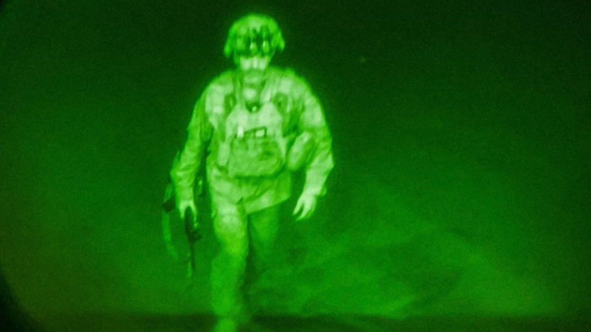 U.S. Army Major General Chris Donahue, commander of the 82nd Airborne Division, steps on board a transport plane as what the XVIII Airborne Corps calls the last Soldier to leave Kabul, Afghanistan August 30, 2021 in a photograph using night vision optics. XVIII Airborne Corps/Handout via REUTERS. 