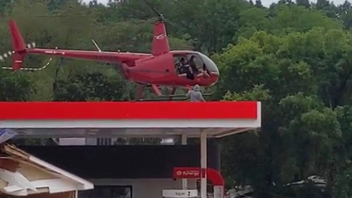This image from video provided by Jeani Rice-Cranford shows Nashville-based helicopter pilot Joel Boyers rescuing people from a rooftop, Saturday, Aug. 21, 2021 in Waverly, Tenn. Boyers, who co-owns Helistar Aviation, said he ended up rescuing 17 people that day. He’s proud of that, but said he’s the one who should be thanking them.