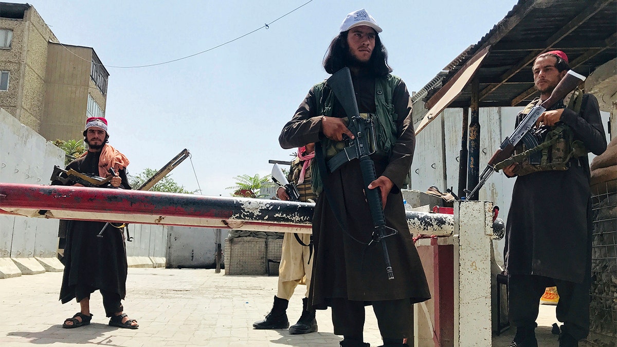 Taliban fighters stand guard at a checkpoint near the US embassy that was previously manned by American troops, in Kabul, Afghanistan, Tuesday, Aug. 17, 2021. 