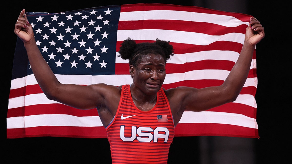 USA's Tamyra Marianna Stock Mensah celebrates her gold medal victory against Nigeria's Blessing Oborududu in their women's freestyle 68kg wrestling final match during the Tokyo 2020 Olympic Games
