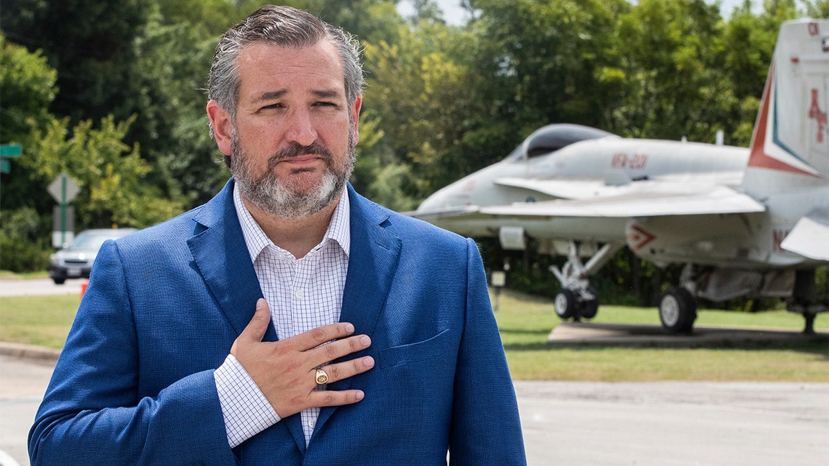 Sen. Ted Cruz puts one hand on his chest as he tours the Naval Air Station Joint Reserve Base Thursday, Aug. 19, 2021, in Fort Worth, Texas.