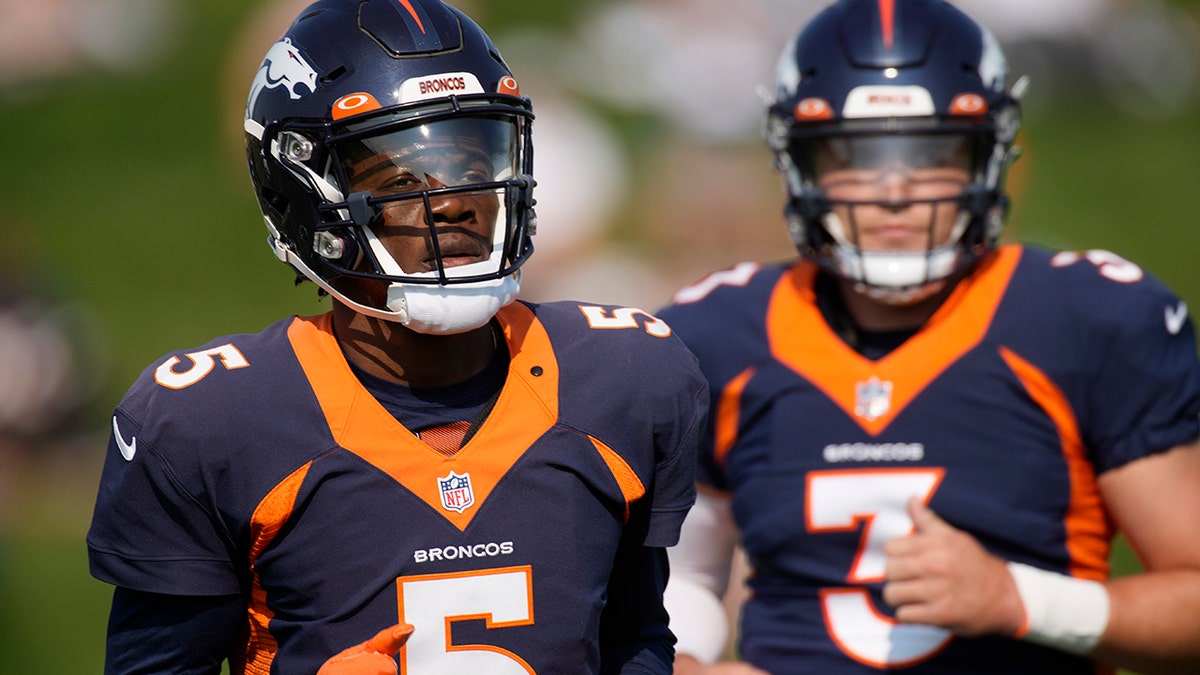 Denver Broncos quarterbacks Teddy Bridgewater, front, and Drew Lock take part in drills during an NFL football training camp at the team's headquarters Tuesday, Aug. 17, 2021, in Englewood, Colo. (AP Photo/David Zalubowski)