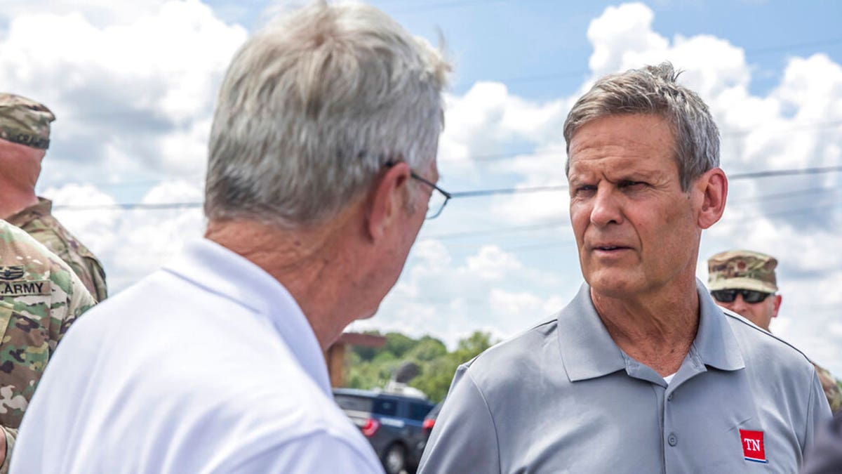 Gov. Bill Lee, right, greets officials upon arriving in Waverly, Tenn., Sunday, Aug. 22, 2021, to inspect flood damage in the area. (Alan Poizner/The Tennessean via AP, Pool)