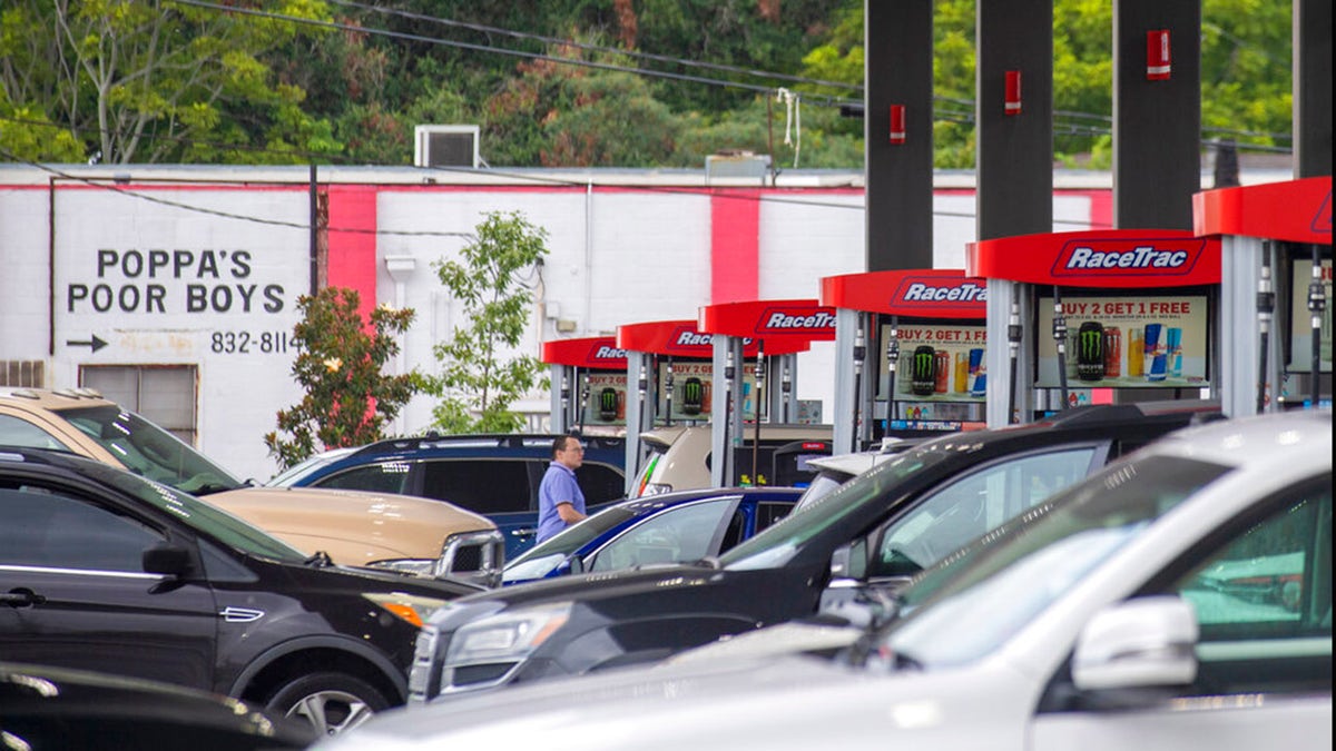 Long lines crisscrossing at a Race Track gas station on Jefferson Highway in Jefferson, La., as people prepare for the arrival of Hurricane Ida on Friday, Aug. 27, 2021. Forecasters now say Ida could be a major Category 3 hurricane with top winds of 115 mph when it nears the U.S. coast.