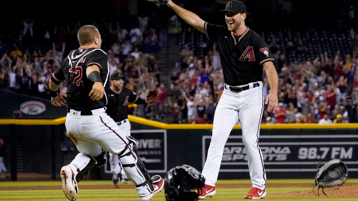Arizona Diamondbacks starting pitcher Tyler Gilbert, right, celebrates after his no-hitter in a baseball game against the San Diego Padres with catcher Daulton Varsho, Saturday, Aug. 14, 2021, in Phoenix. It was Gilbert's first career start. The Diamondbacks won 7-0. (AP Photo/Matt York)