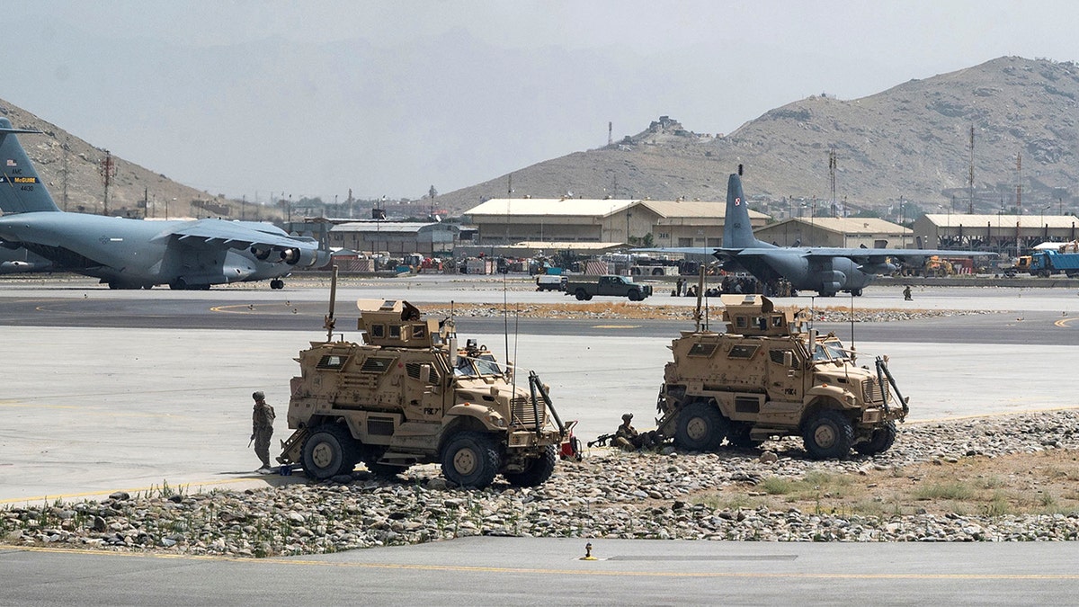 U.S. Army soldiers assigned to the 82nd Airborne Division patrol Hamid Karzai International Airport in Kabul, Afghanistan Aug. 17, 2021. (U.S. Air Force/Senior Airman Taylor Crul/Handout via REUTERS)