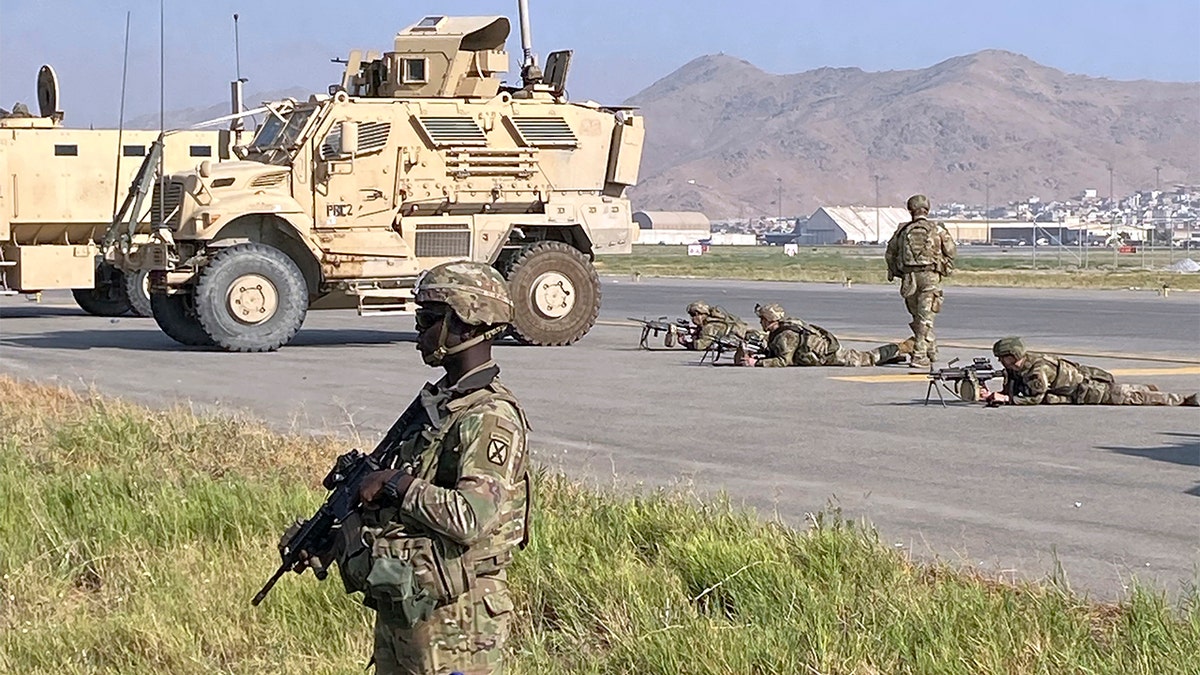 U.S soldiers stand guard along a perimeter at the international airport in Kabul, Afghanistan, on Monday.