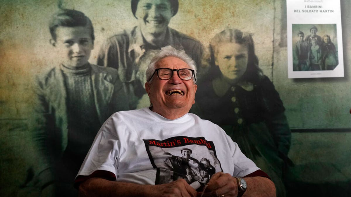 A 97 year old retired American soldier Martin Adler smiles as he arrives at Bologna's airport, Italy, Monday, Aug. 23, 2021. For more than seven decades, Martin Adler treasured a back-and-white photo of himself as a young soldier with a broad smile with three impeccably dressed Italian children he is credited with saving as the Nazis retreated northward in 1944. The 97-year-old World War II veteran met the three siblings -- now octogenarians themselves -- in person for the first time on Monday, eight months after a video reunion.