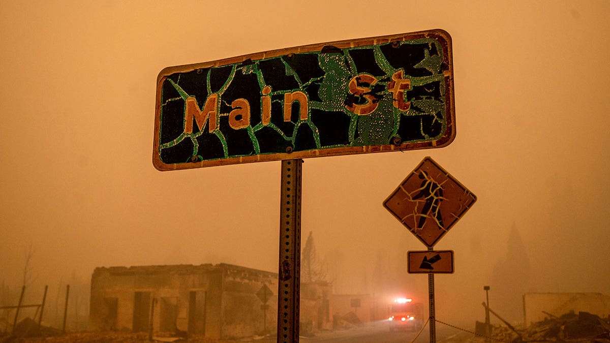 A fire truck drives through central Greenville, which was largely leveled by the Dixie Fire, Friday, Aug. 6, 2021, in Plumas County, Calif. 