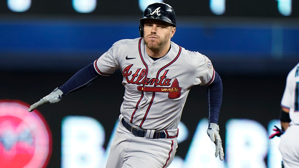 Atlanta Braves' Freddie Freeman rounds second base as he gets a triple during the fourth inning of a baseball game against the Miami Marlins, Wednesday, Aug. 18, 2021, in Miami. (Associated Press)