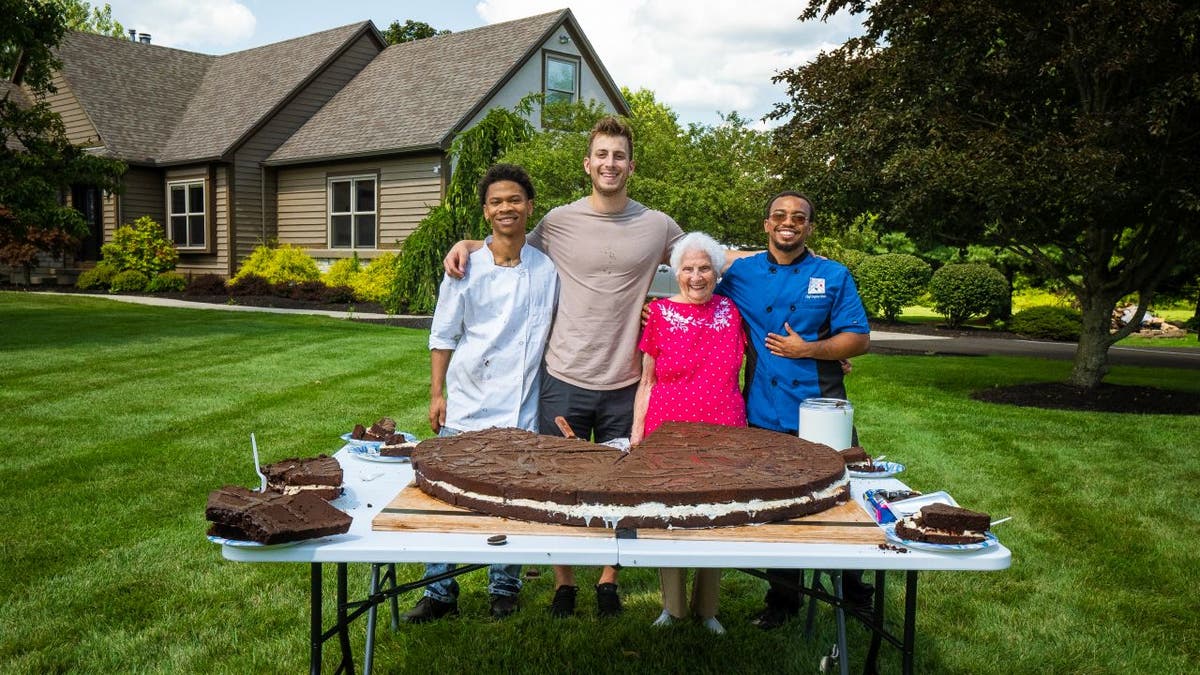 From left to right: Chef Roddy Martin, social media influencers Ross Smith and Gangster Granny and chef Stephen Miller pose with the 180-pound Oreo cookie they baked together in Ohio.