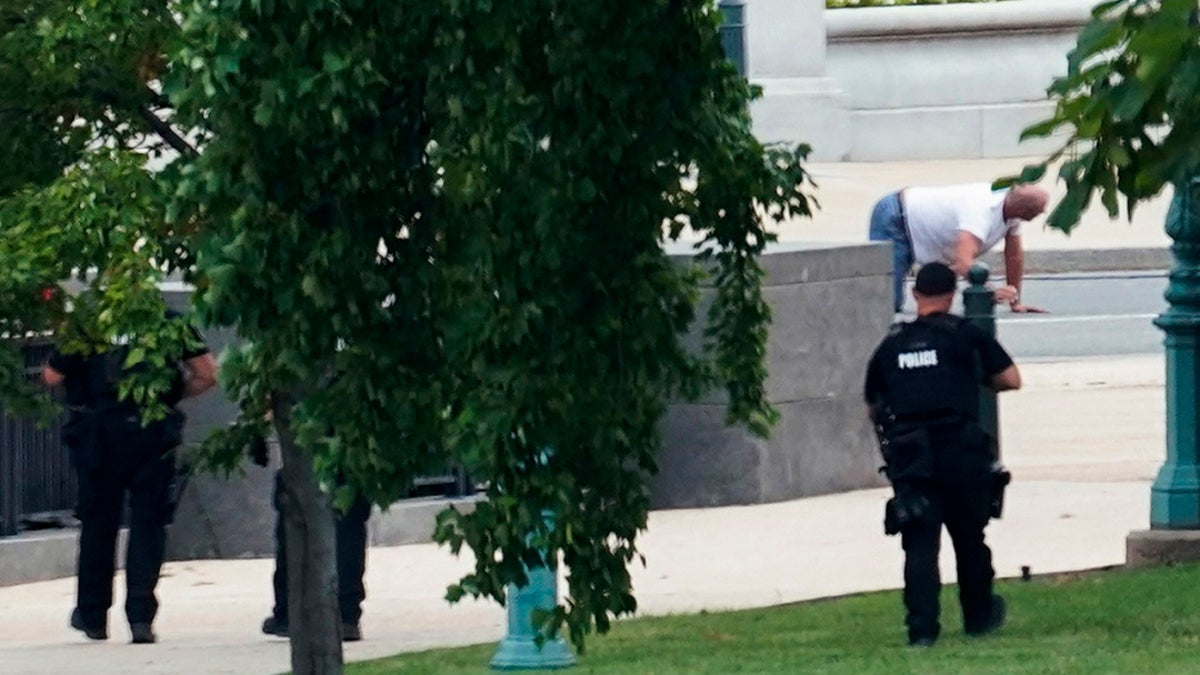 Floyd Ray Roseberry apprehended after being in a pickup truck parked on the sidewalk in front of the Library of Congress' Thomas Jefferson Building, as seen from a window of the U.S. Capitol on Thursday. (AP Photo/Alex Brandon)