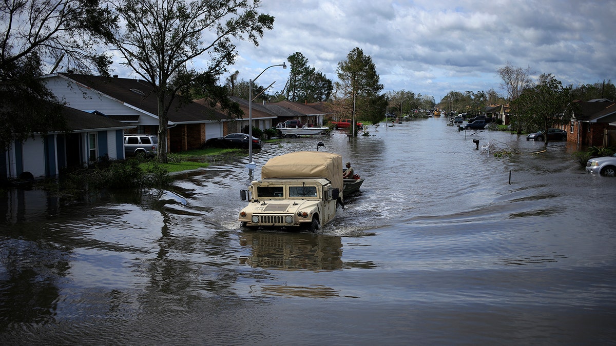 A National Guard vehicle drives through floodwater left behind by Hurricane Ida in LaPlace, Louisiana, on Monday, Aug. 30, 2021. The storm, wielding some of the most powerful winds ever to hit the state, drove a wall of water inland when it thundered ashore Sunday as a Category 4 hurricane and reversed the course of part of the Mississippi River. 