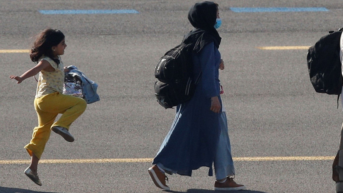 A moving photo of a young Afghan girl skipping on the tarmac of a Belgian airport after being evacuated from her war-torn native country has gone viral. 